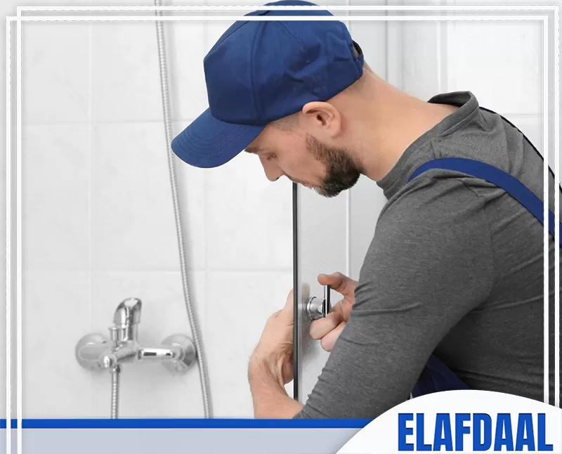 اسعار تركيب شاور بوكس زجاج بجدة 0547648005 شركة الأفضل فنيًا يثبت مقبض كابينة شاور زجاجية داخل الحمام، مع ظهور خلاط الدش والزجاج أثناء أعمال التركيب أو الصيانة.